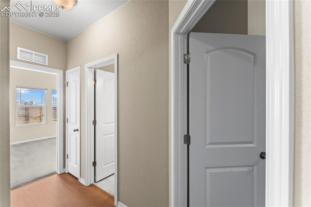 Image 4 of 45: Hall featuring wood finished floors and a textured wall