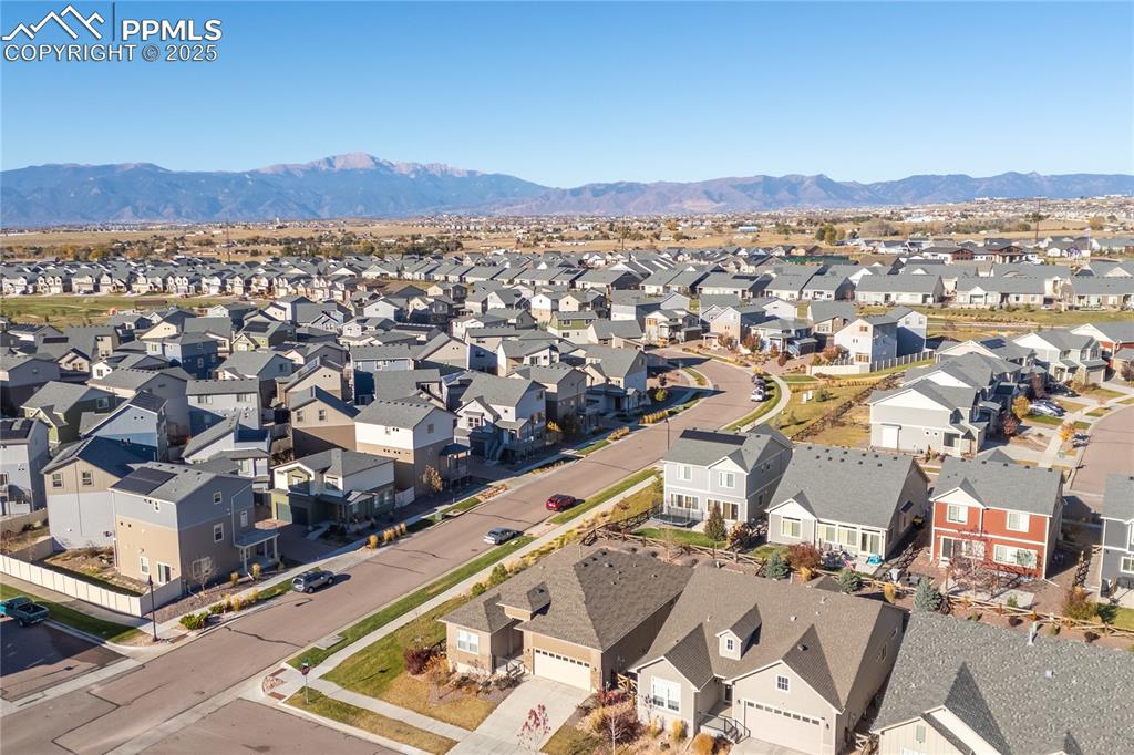 Image 41 of 45: Aerial view of residential area featuring a mountain backdrop