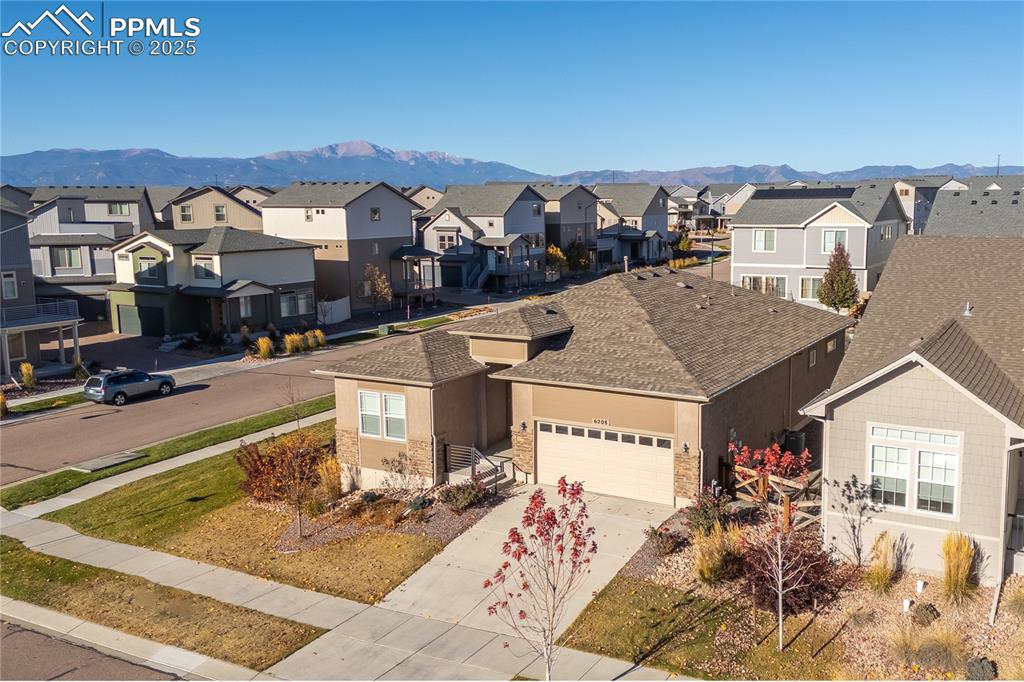 Image 49 of 50: View of front of home featuring concrete driveway, a mountain view, a garag