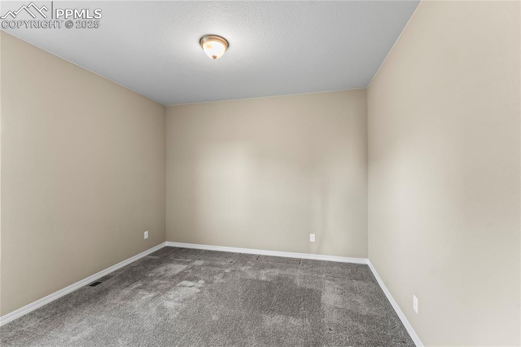 Image 5 of 45: Spare room featuring carpet and baseboards