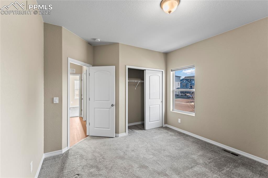 Image 6 of 45: Unfurnished bedroom with carpet flooring and a closet
