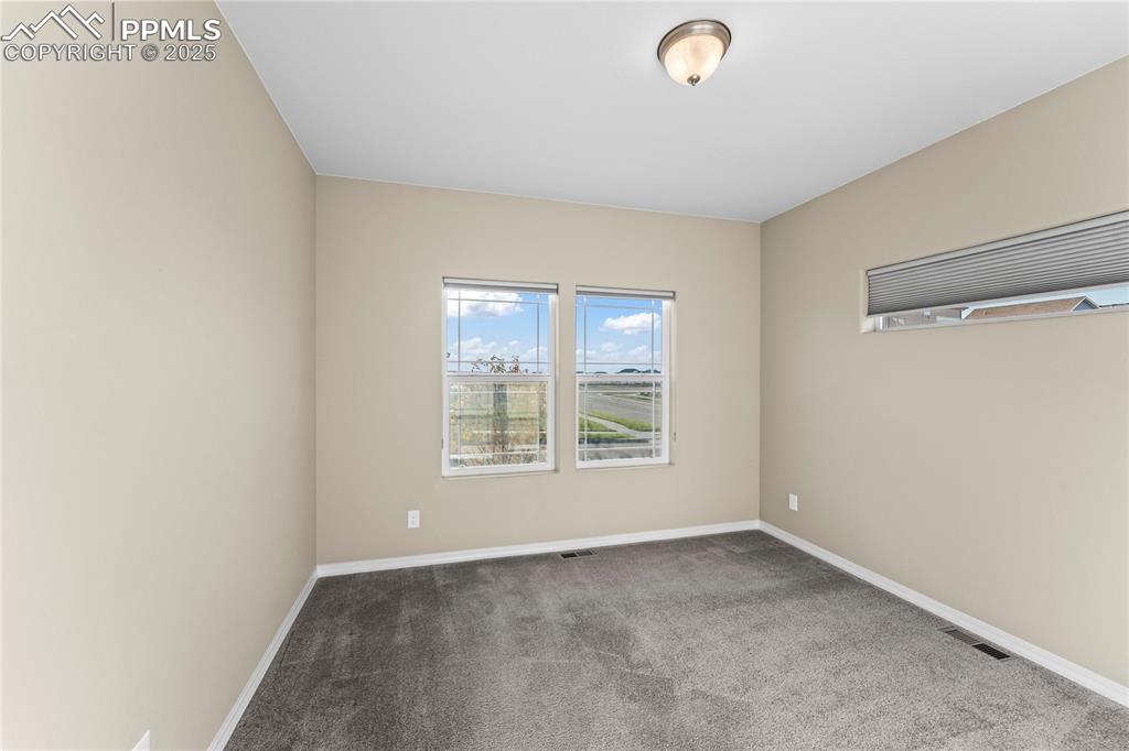 Image 8 of 45: Spare room with carpet floors and baseboards