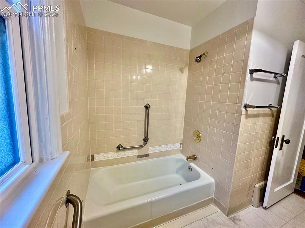 Image 15 of 28: Full bath with bathtub / shower combination and tile patterned flooring