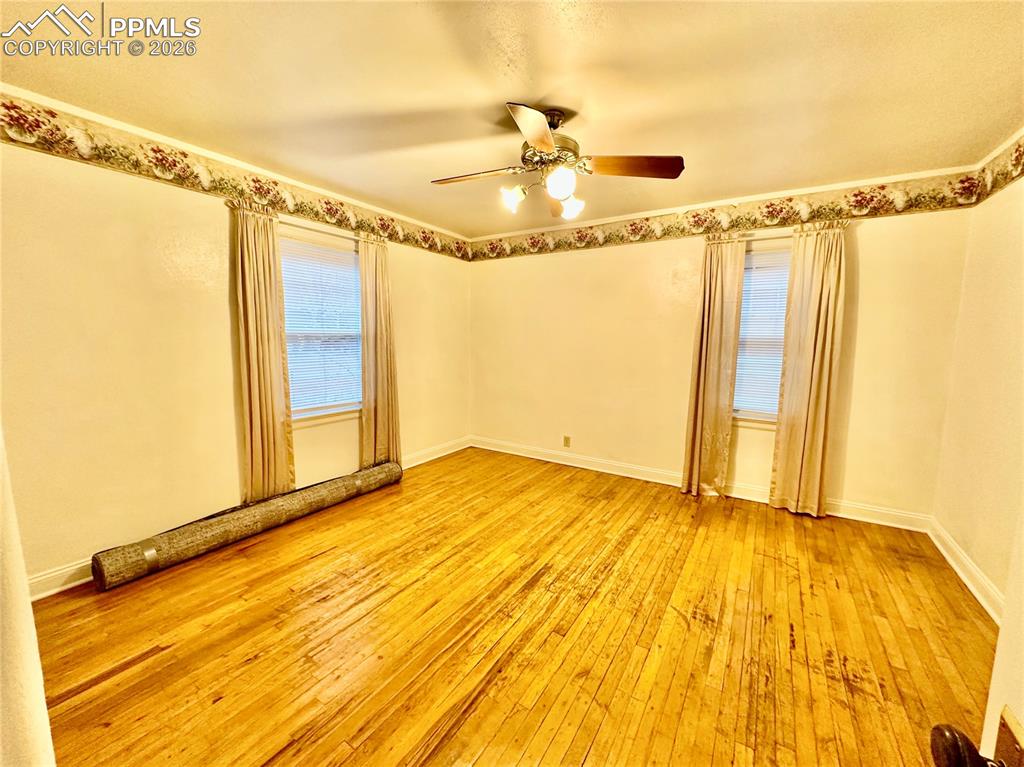 Image 16 of 28: Empty room with light wood finished floors and baseboards