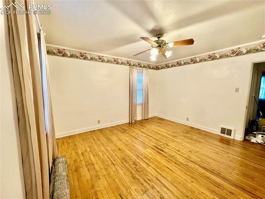Image 17 of 28: Unfurnished room featuring light wood-style flooring and a ceiling fan