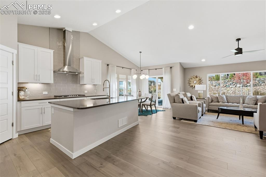 Image 20 of 49: Bright great room flows seamlessly into the dining area and gourmet kitchen
