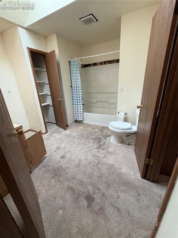 Image 11 of 12: Full bathroom featuring a white tub and shower combination with an overhead