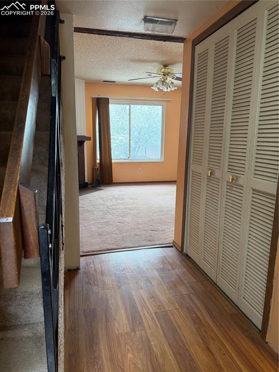 Image 2 of 12: Entryway featuring wood-finish flooring, louvered bi-fold doors, and a ceil