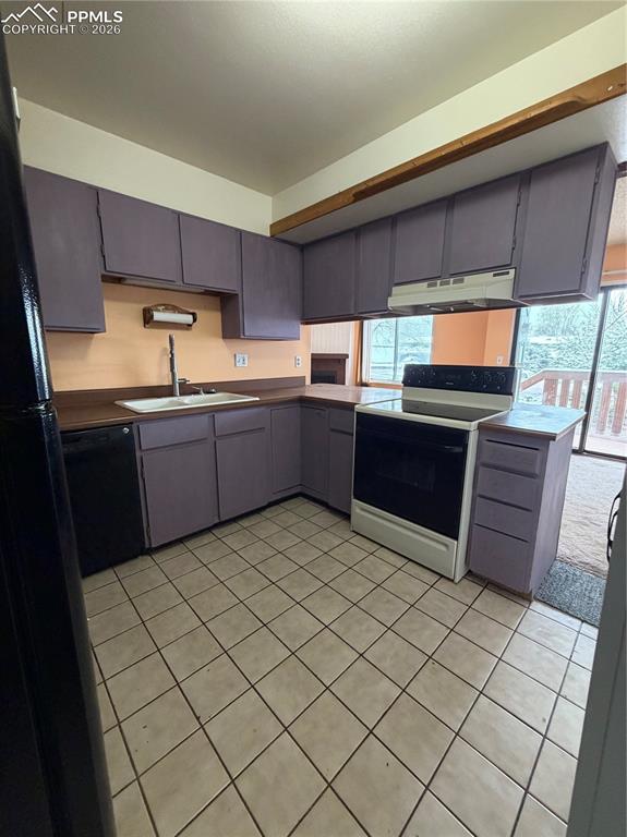 Image 4 of 12: Kitchen featuring purple cabinetry, wood-finish countertops, tile flooring,