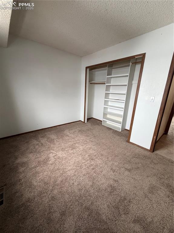 Image 7 of 12: Room featuring wall-to-wall brown carpet