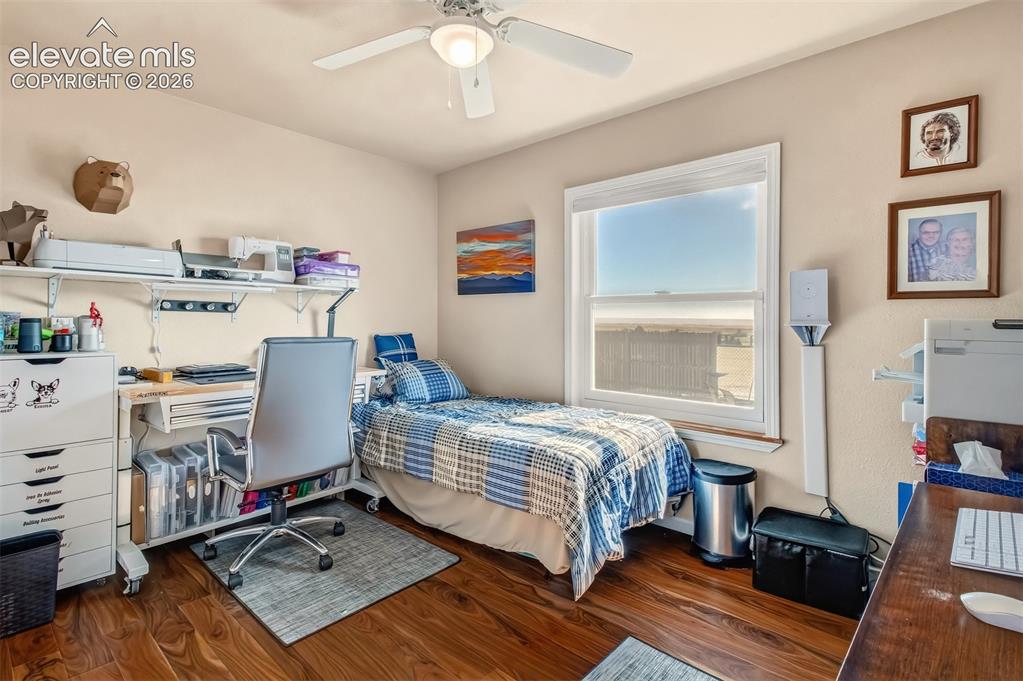 Image 18 of 43: 2nd bedroom on main level, currently being used as an office/craft room.