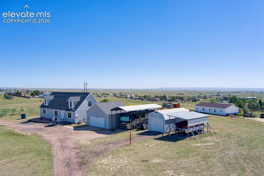 Image 2 of 43: Plenty of covered parking! 2 car garage, 14x40 RV carport with 14ft of clea