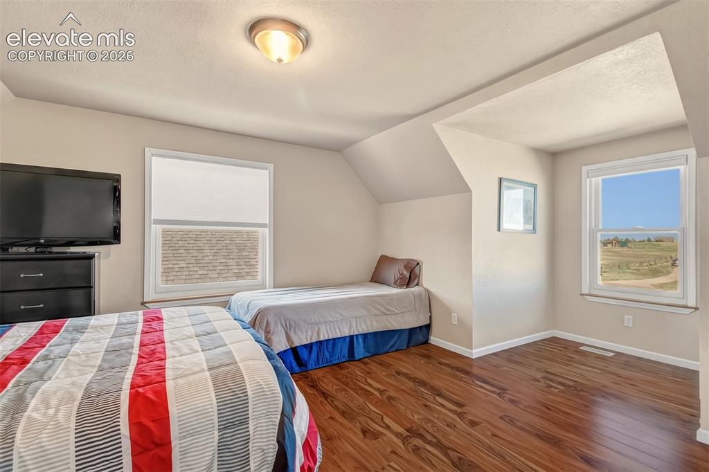 Image 23 of 43: Upper level bedroom with beautiful views, dormer window.