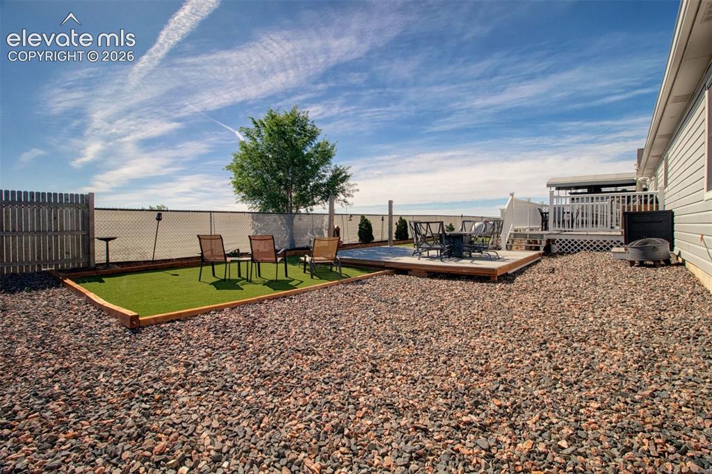 Image 32 of 43: Xeriscape backyard with multiple entertaining and relaxing spaces