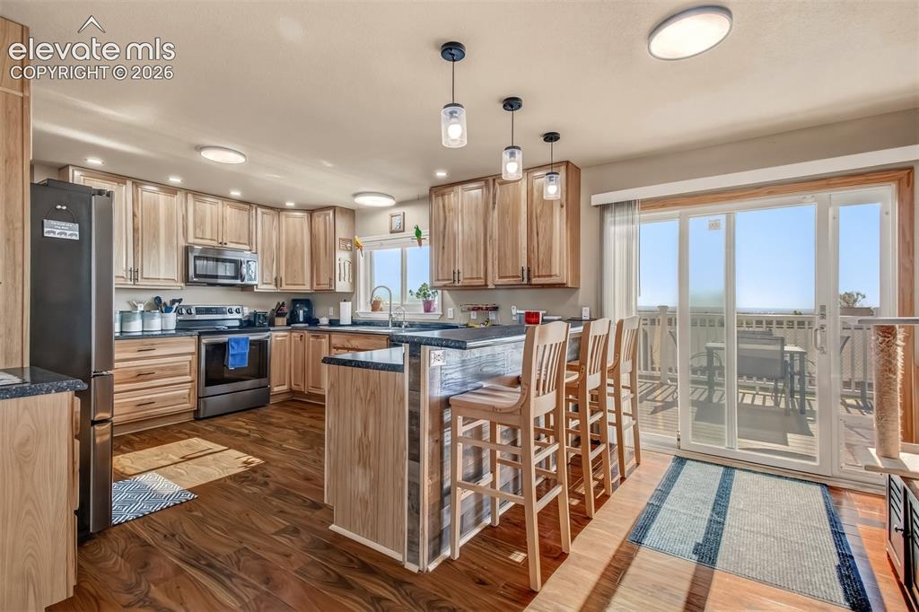 Image 6 of 43: Wonderful updated kitchen with 42 inch hickory cabinet uppers, LED lighting