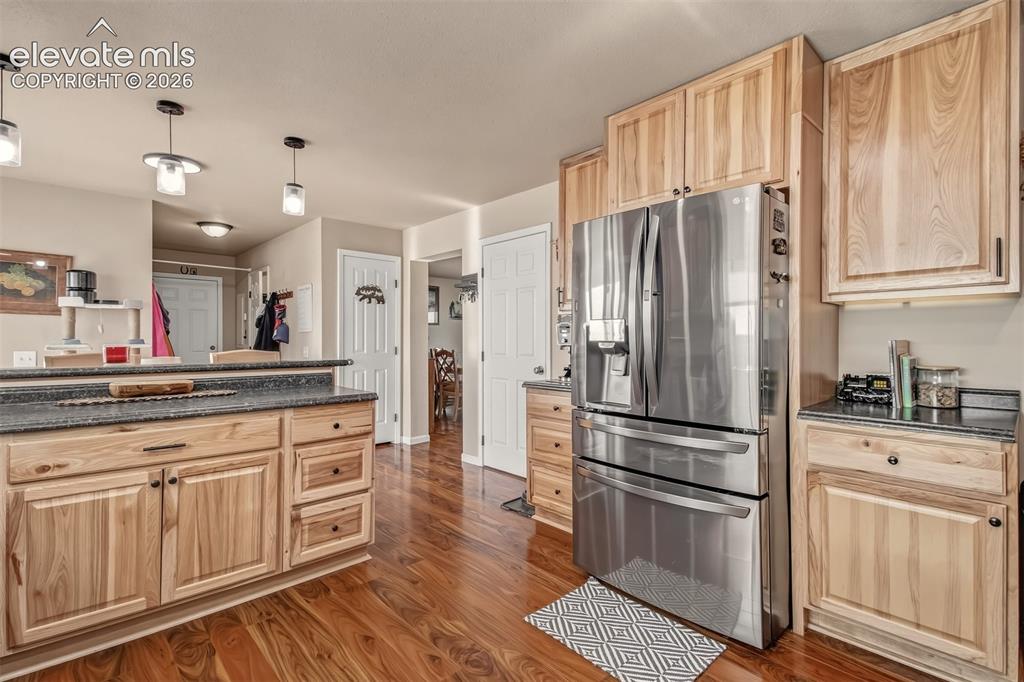 Image 9 of 43: Alternate view of kitchen, pendant lights, pantry area.