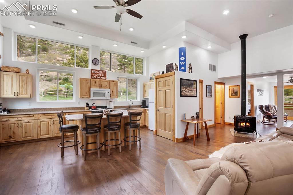 Image 16 of 33: A nice big kitchen with windows that will draw you in like a good novel tel