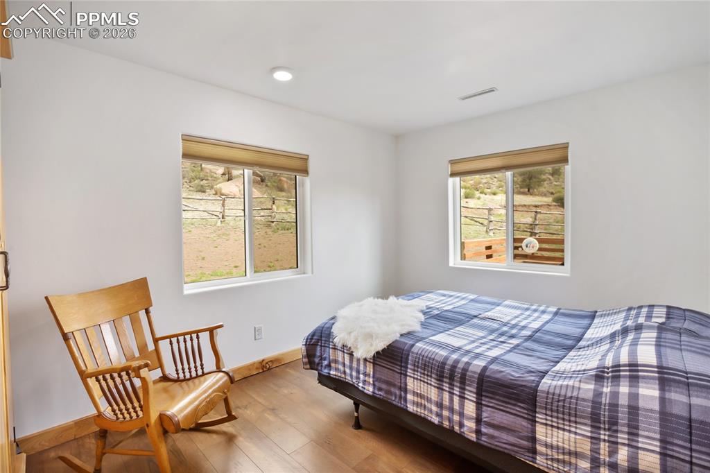 Image 23 of 33: Bedroom 3 of 3, with two big windows.