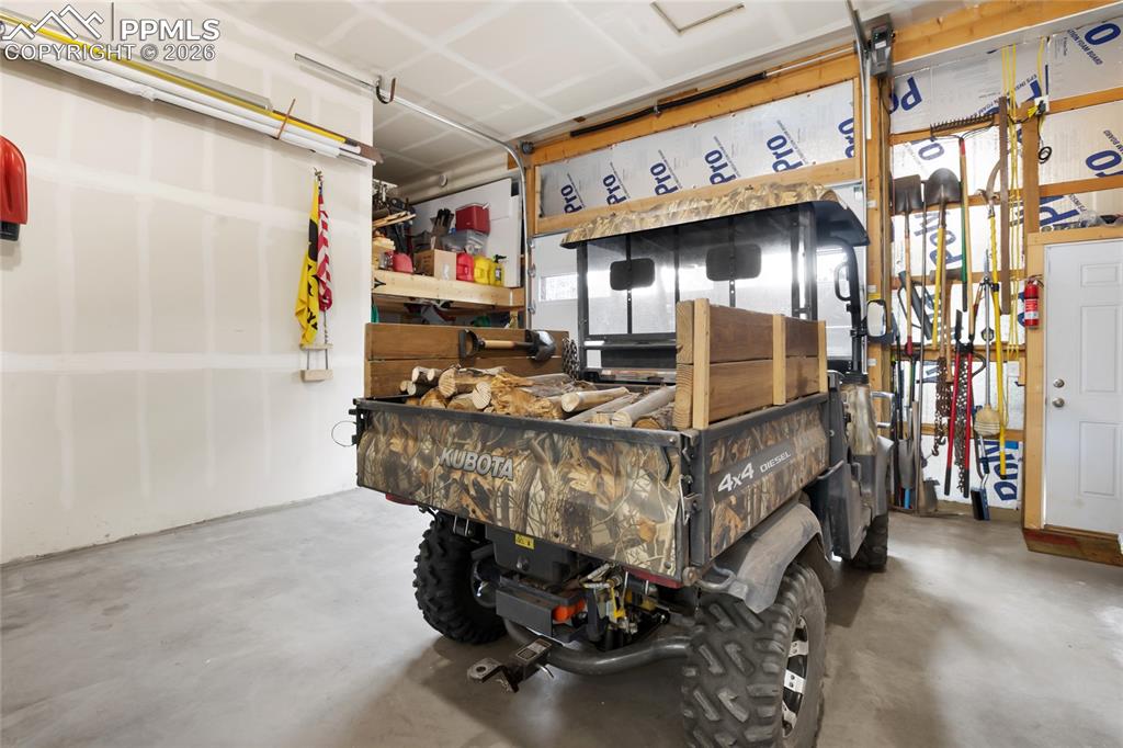 Image 25 of 33: HUGE garage for your car, your ATV and all your storage too!