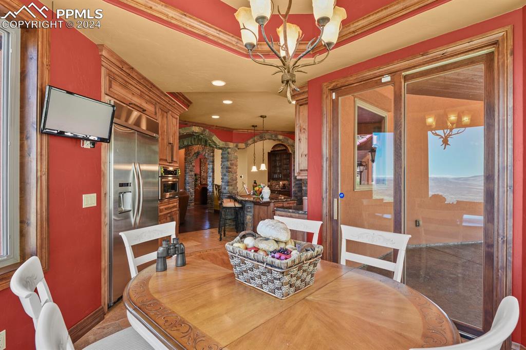 Image 13 of 50: Tiled dining area with an inviting chandelier