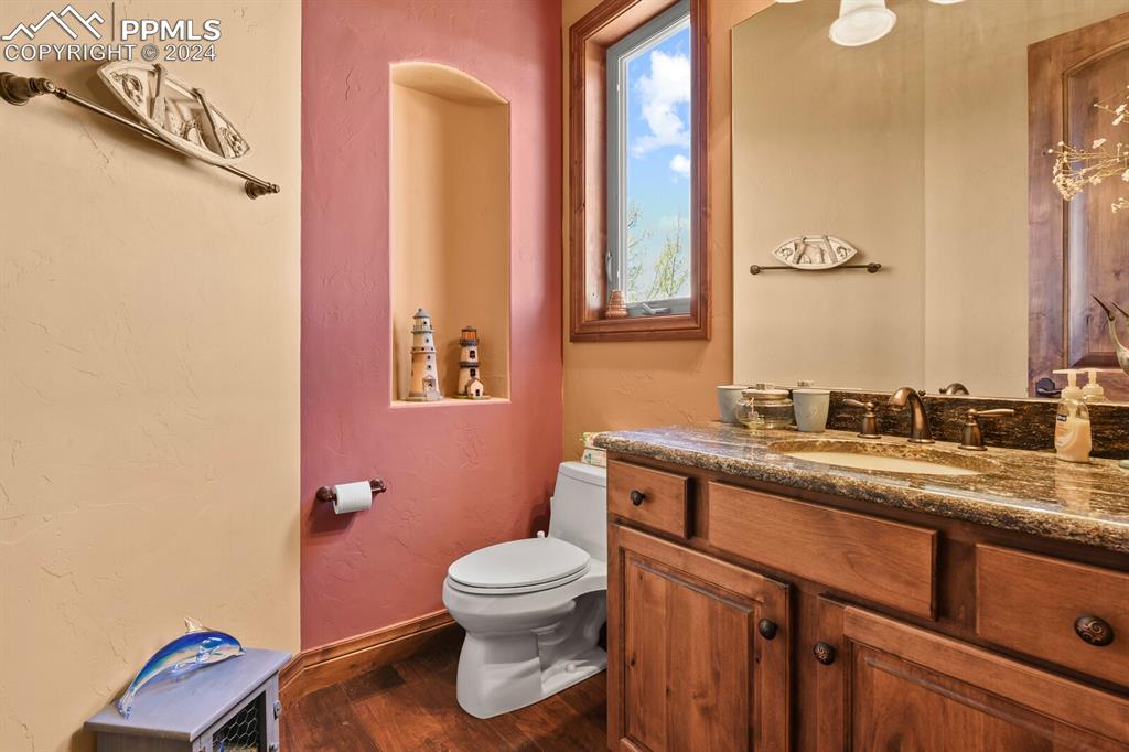 Image 14 of 50: Bathroom with wood-type flooring, vanity, and toilet