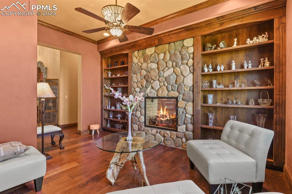 Image 15 of 50: Living room with hardwood / wood-style flooring, a fireplace, and ceiling f