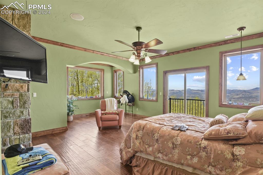 Image 20 of 50: Bedroom with ornamental molding, access to exterior, ceiling fan, and dark 