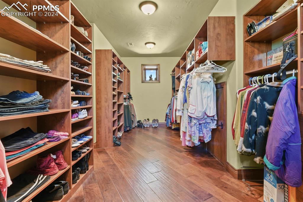 Image 24 of 50: Spacious closet featuring hardwood / wood-style flooring