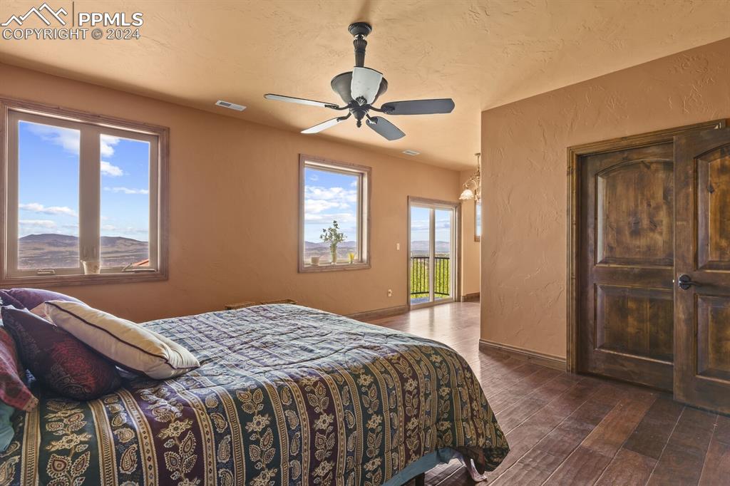 Image 27 of 50: Bedroom with dark hardwood / wood-style flooring and ceiling fan