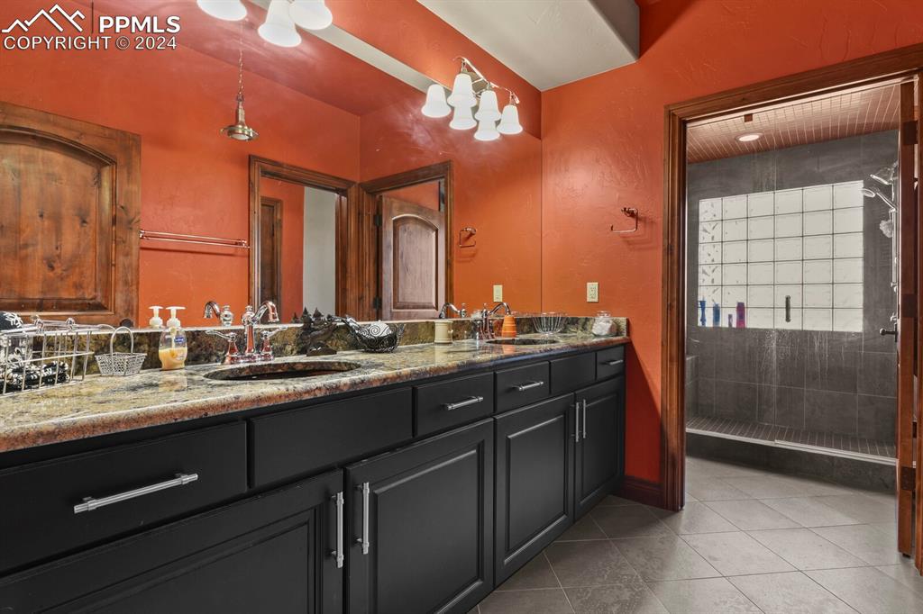 Image 34 of 50: Bathroom featuring tile flooring and double sink vanity