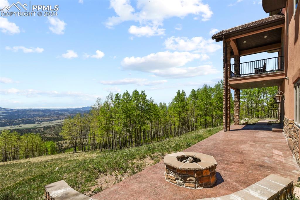 Image 38 of 50: View of patio featuring an outdoor fire pit