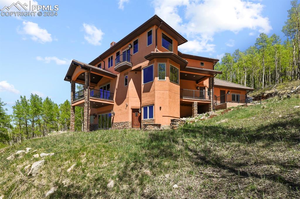 Image 39 of 50: Rear view of house featuring a balcony
