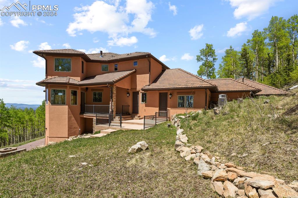 Image 41 of 50: Back of house with a patio and a lawn