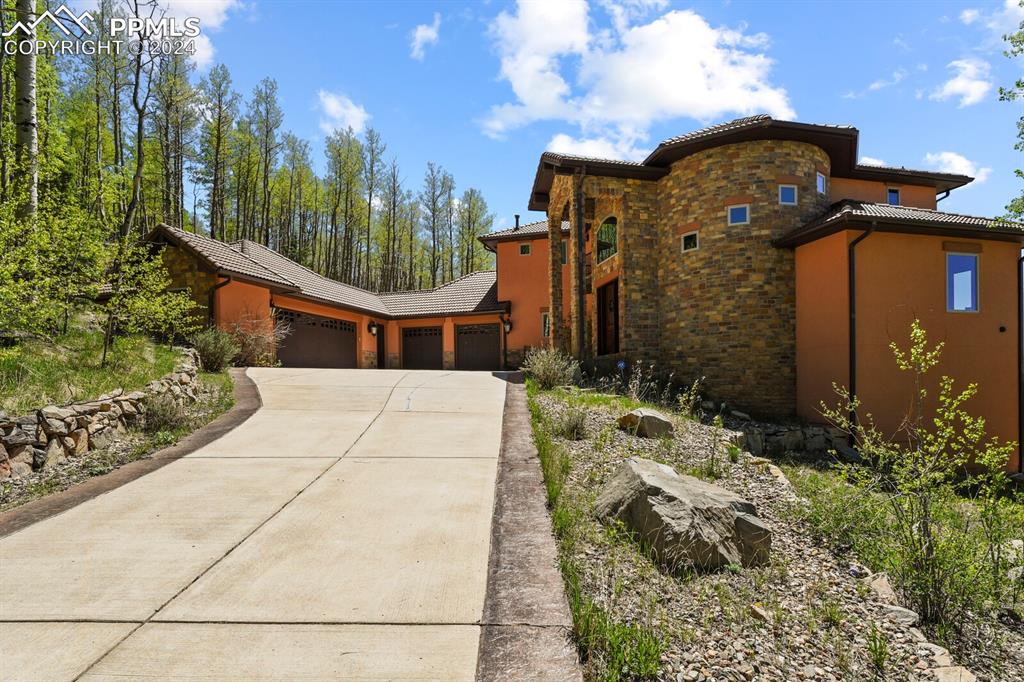 Image 44 of 50: View of front of property with a garage
