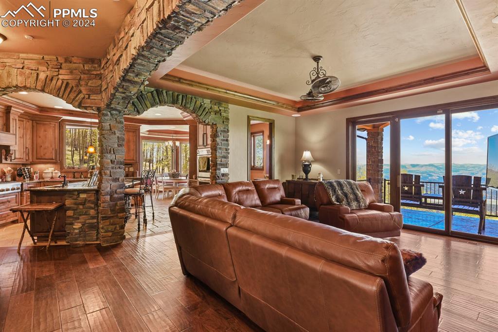 Image 5 of 50: Living room with sink, ornamental molding, hardwood / wood-style flooring, 