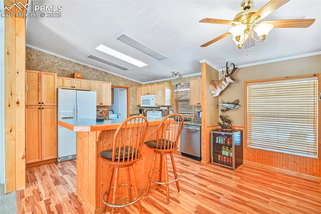 Image 16 of 29: Kitchen with Vaulted Ceiling, Skylight, Breakfast Bar and all Appliances In