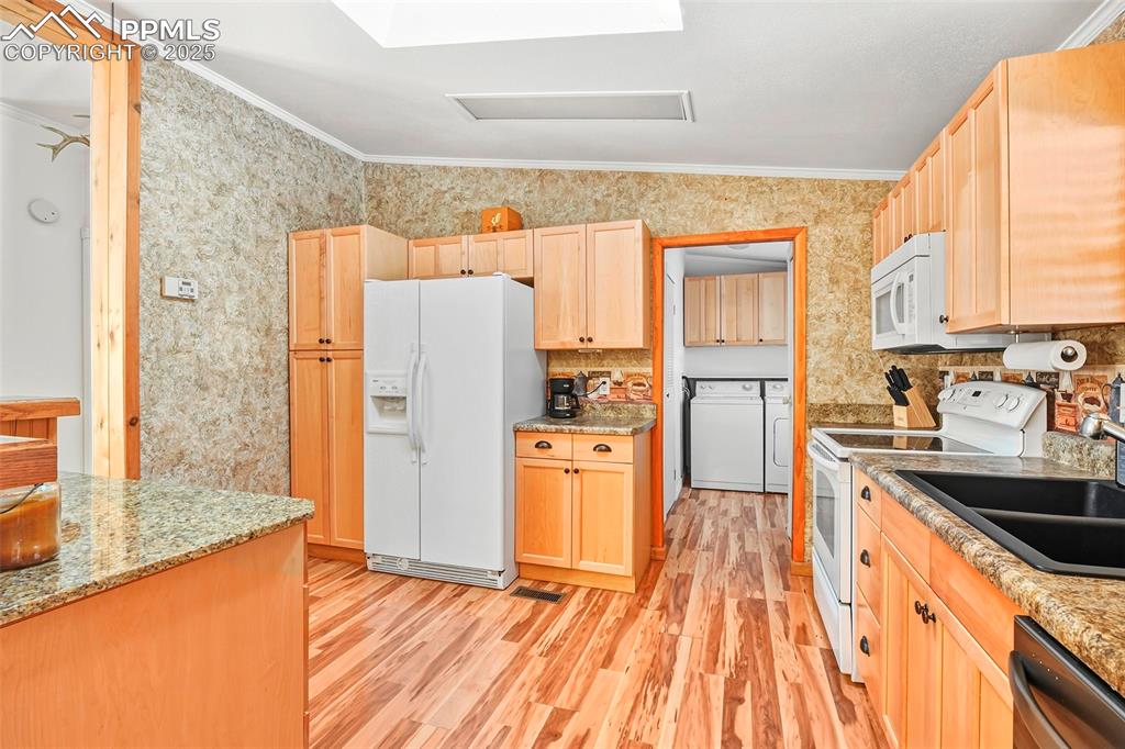 Image 18 of 29: Kitchen with Beautiful Flooring, Vaulted Ceiling and Access to Laundry and 