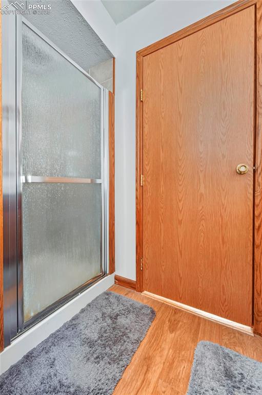 Image 24 of 29: Master Suite Bathroom Off Kitchen with Shower