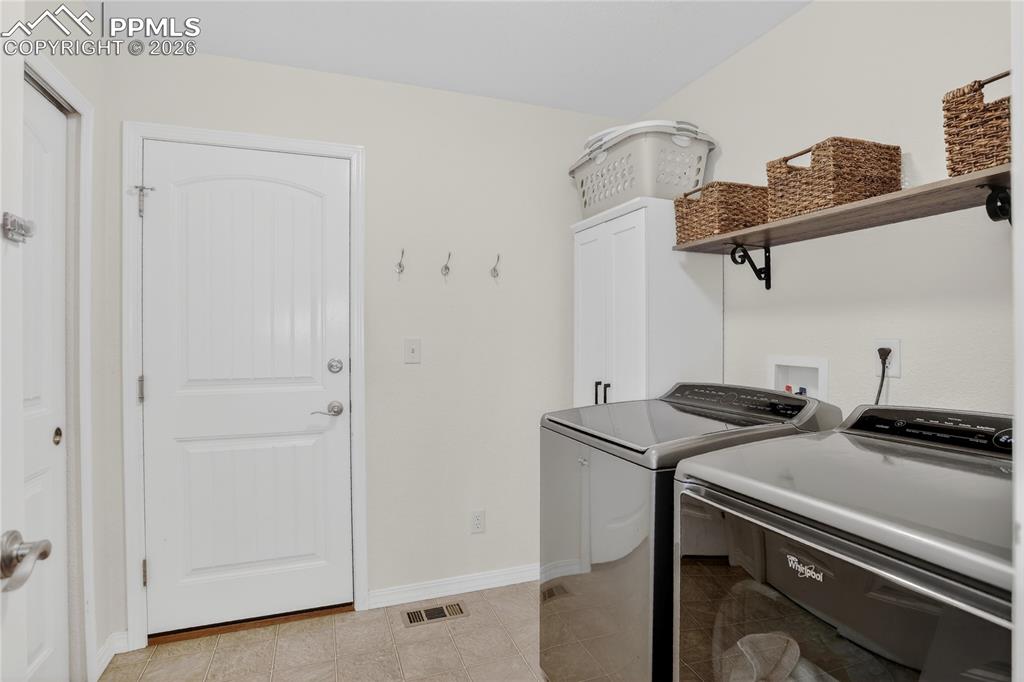 Image 17 of 25: Main level laundry w/ garage access