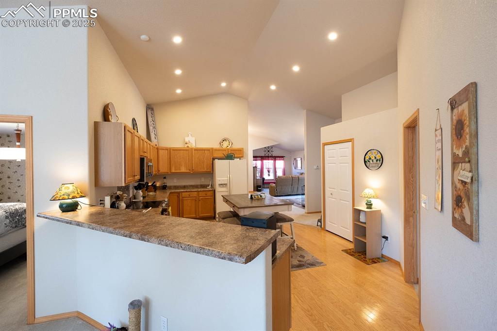 Image 11 of 37: A view from the back of the home through the kitchen to the front.