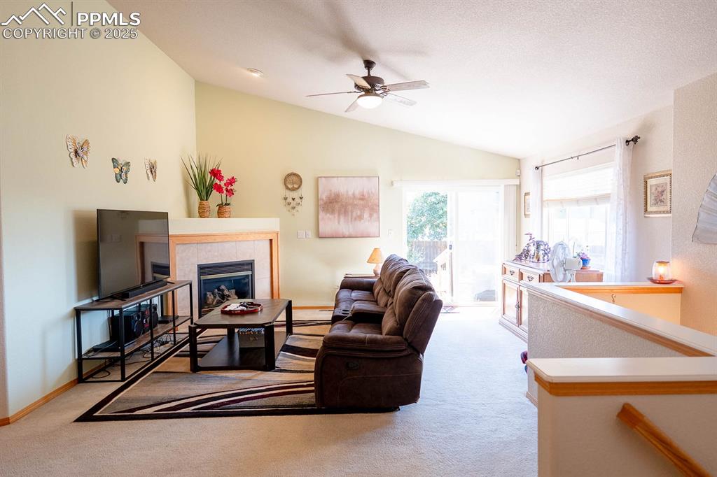 Image 12 of 37: Family room with gas fireplace is at the back of the home.