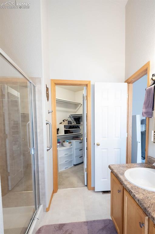 Image 18 of 37: Walk in is off the bathroom area.