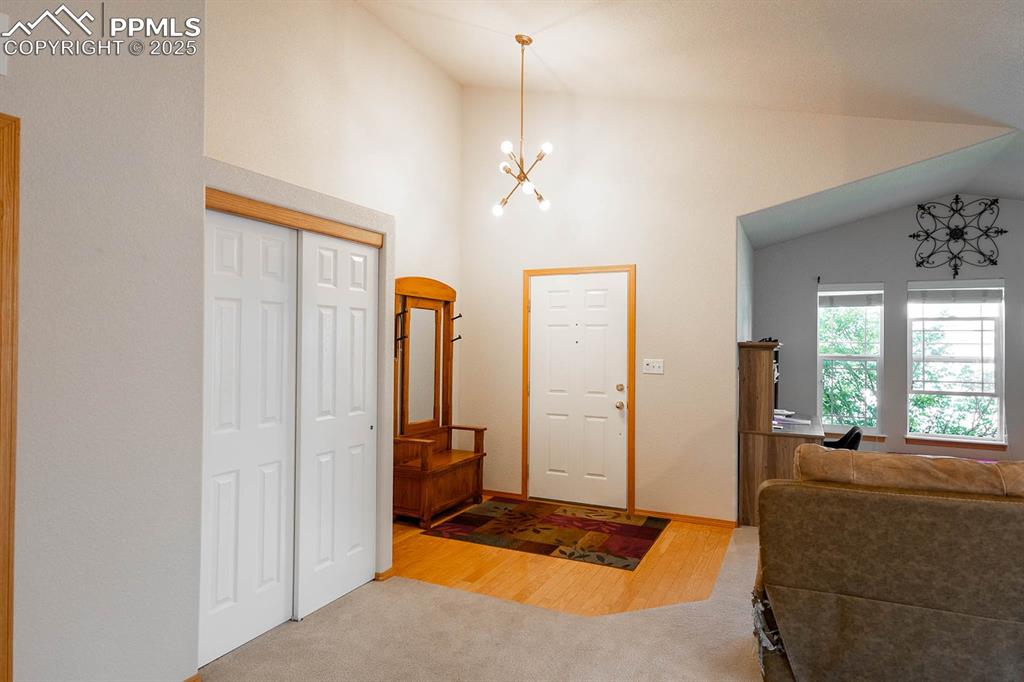 Image 2 of 37: Wood floor entry and room for a bench.  Large coat closet.