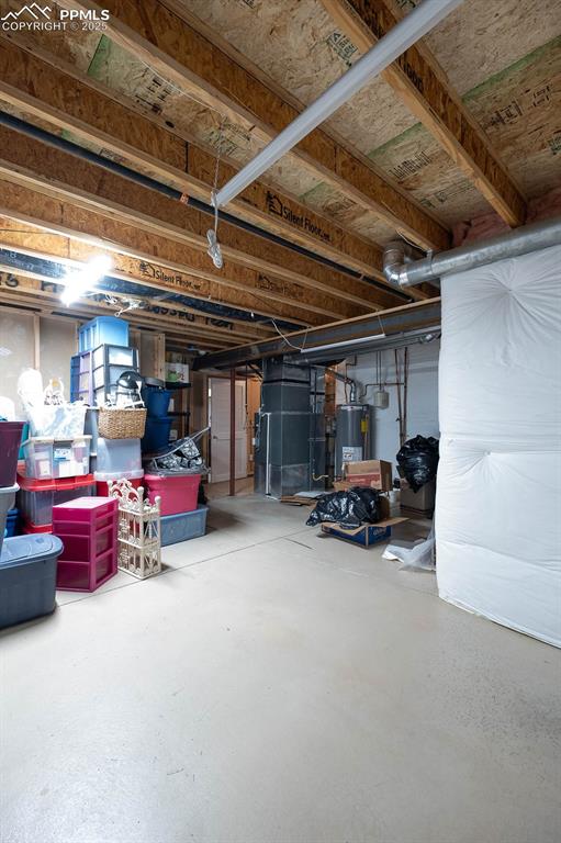 Image 32 of 37: Unfinished area in the basement has a door.