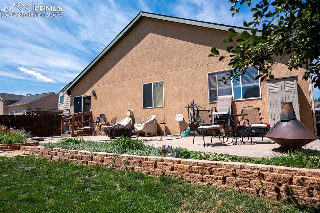 Image 34 of 37: Large patio for furniture and a grill.