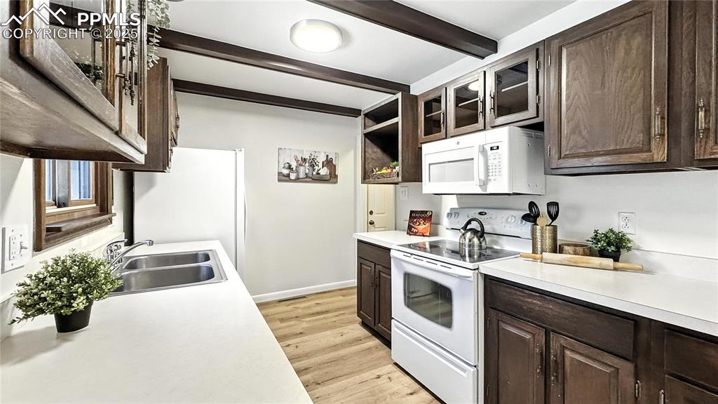 Image 13 of 50: Kitchen has a convenient garage enterance