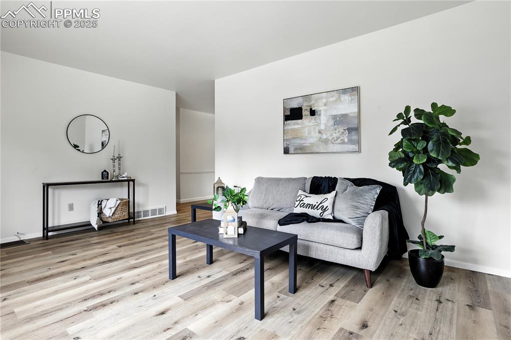 Image 3 of 50: Living room with brand new luxury plank flooring