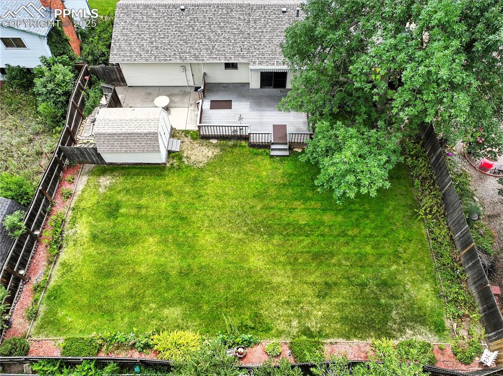 Image 44 of 50: Aerial view of the backyard and spacious lawn