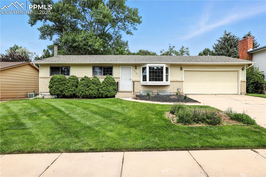 Image 47 of 50: Ranch-style home with brick siding and attached garage