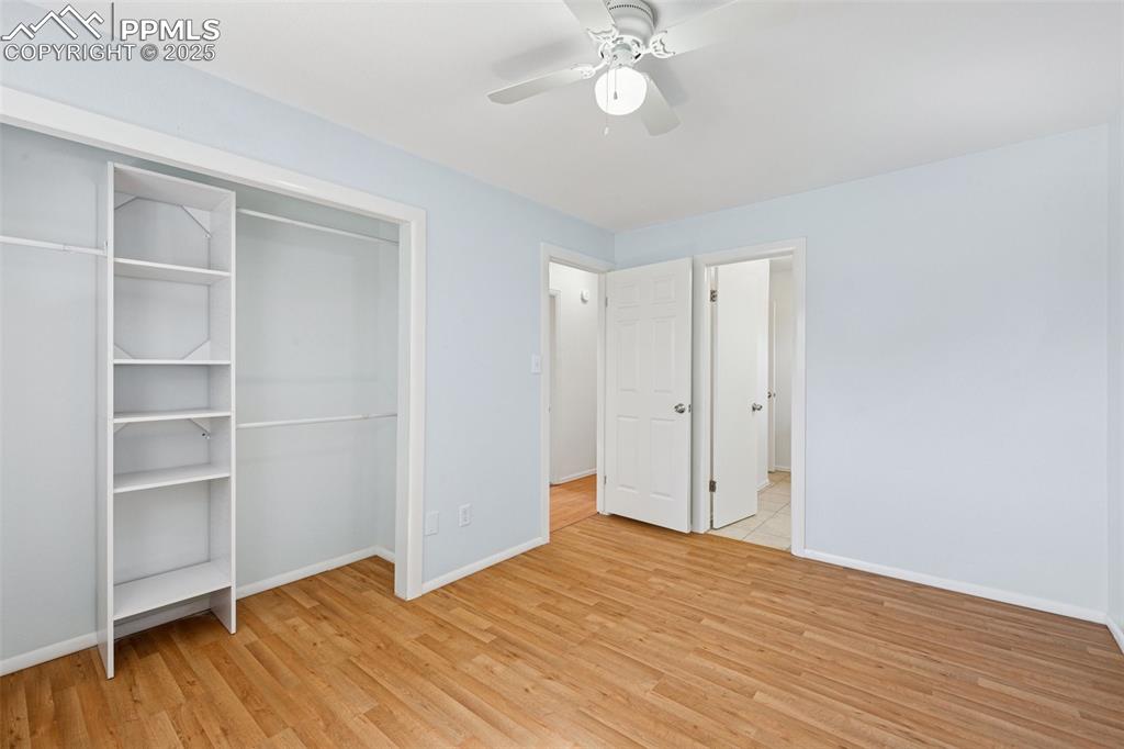 Image 12 of 35: Unfurnished bedroom featuring light wood finished floors, a closet, and a c